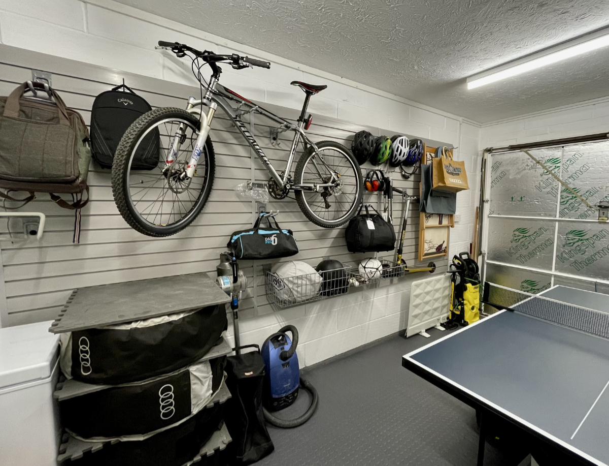 Garage wall storage panels with basket, hooks and hanging bicycle